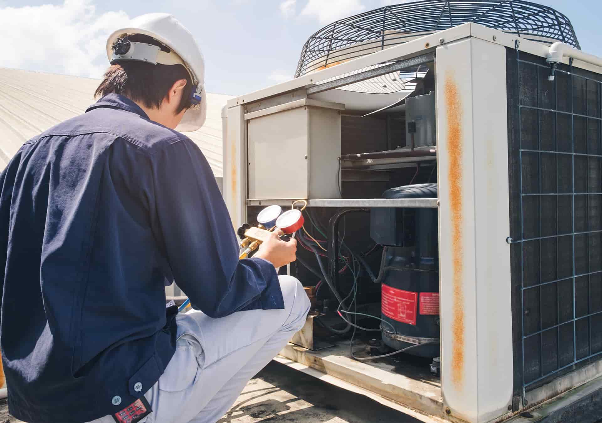 Technician Performs Air Conditioning Maintenance